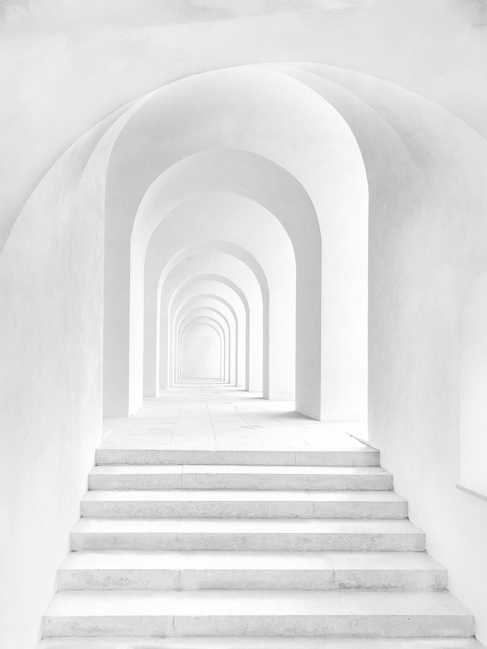 White arched staircase with soft natural light