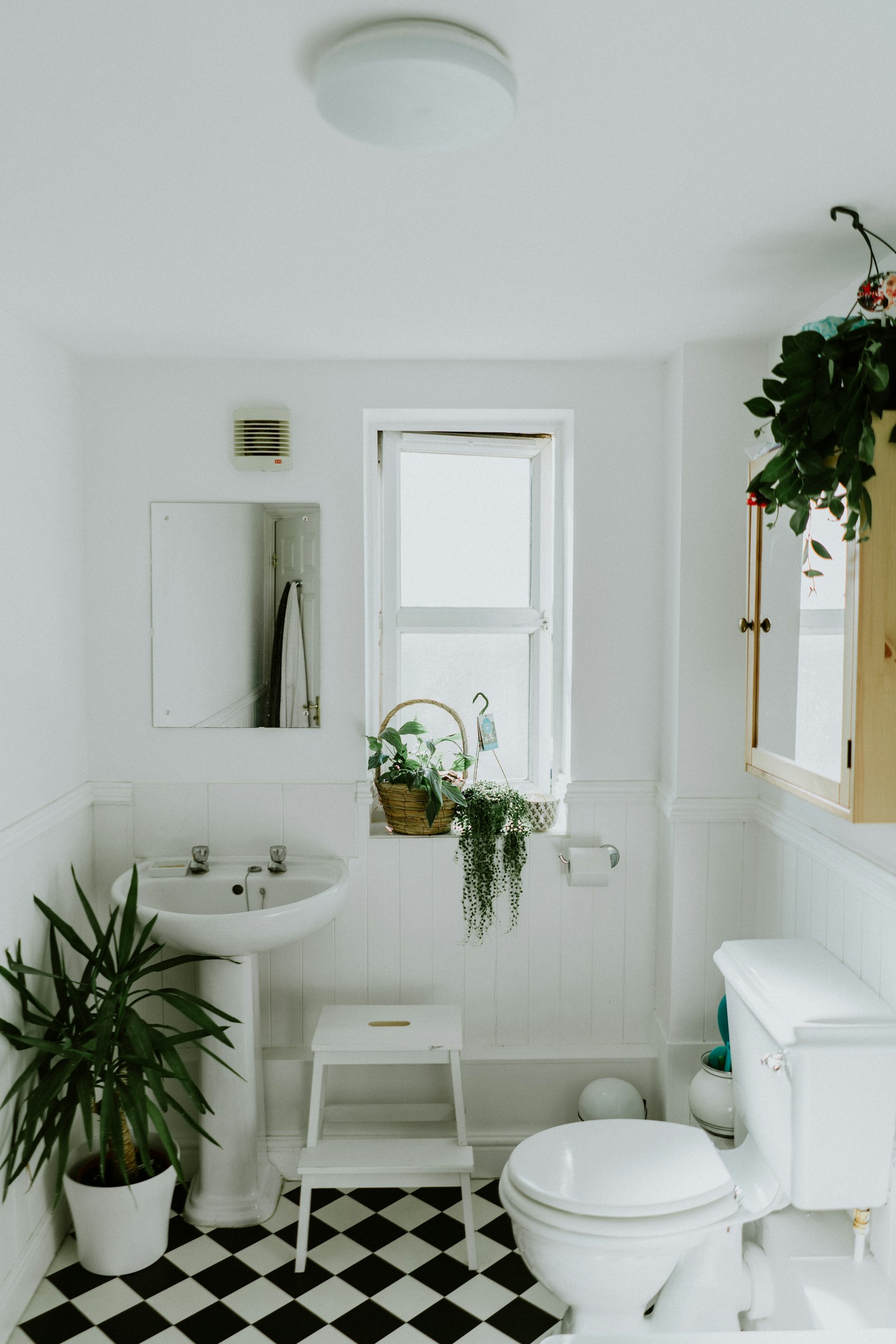 Bright bathroom with white bathtub and round vessel basin