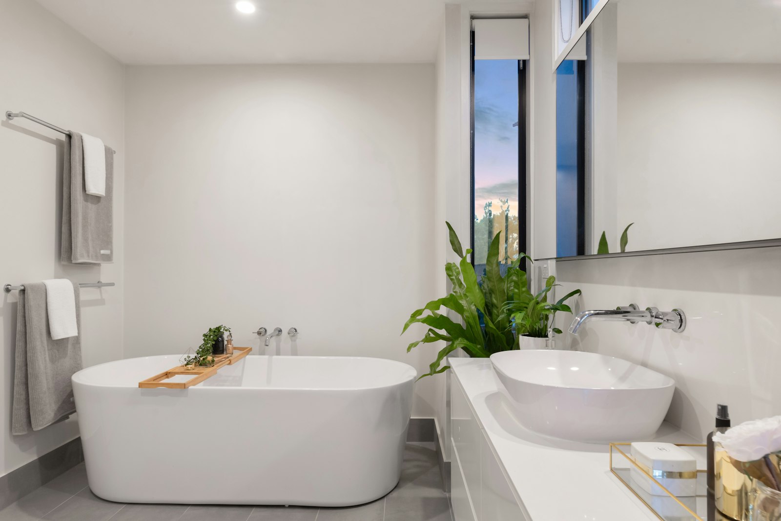 Bright bathroom with freestanding bathtub and window light
