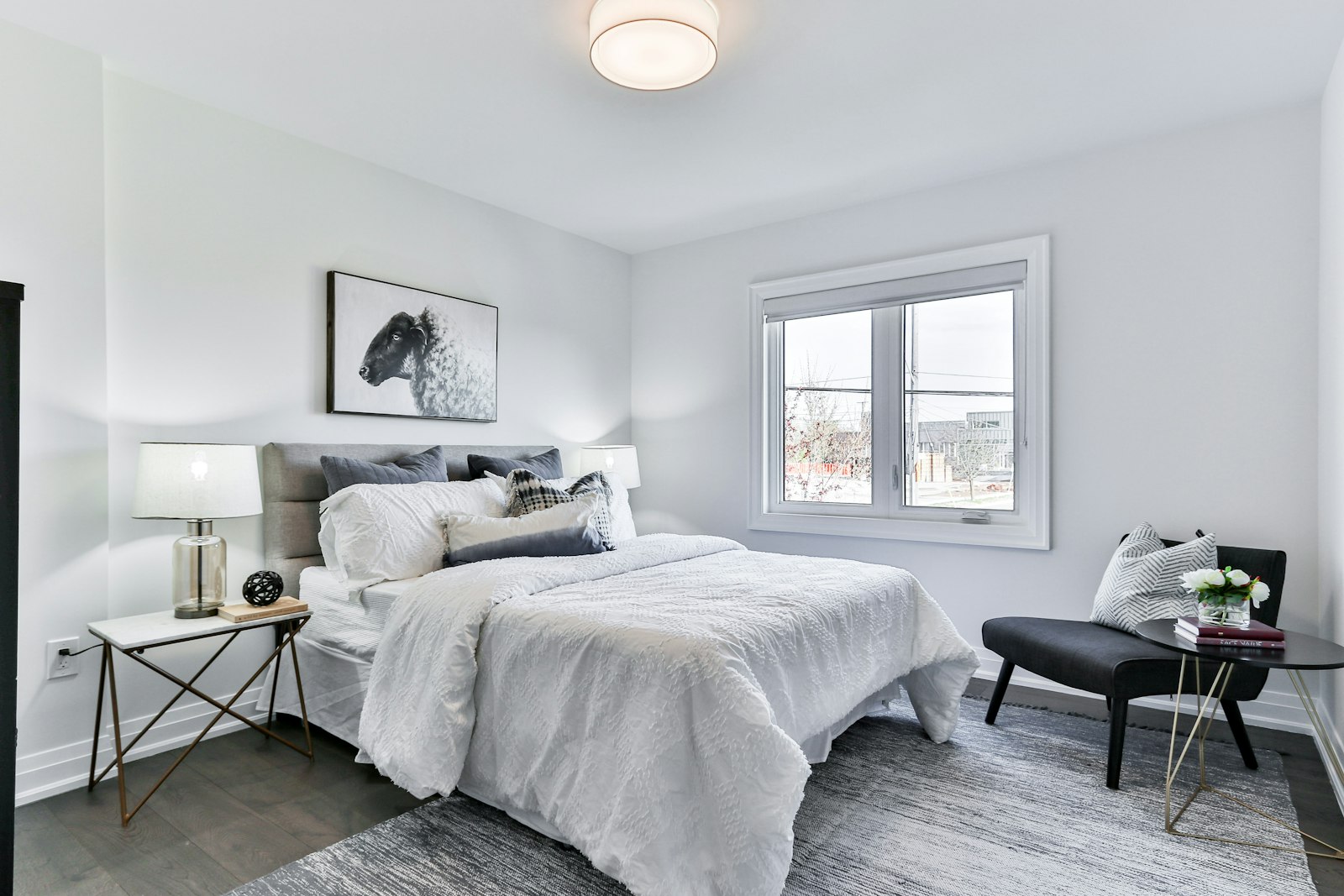 Calm neutral master bedroom with layered grey and white bedding