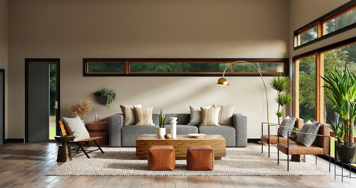 Warm landed-home living room with leather ottomans, timber tones and garden view